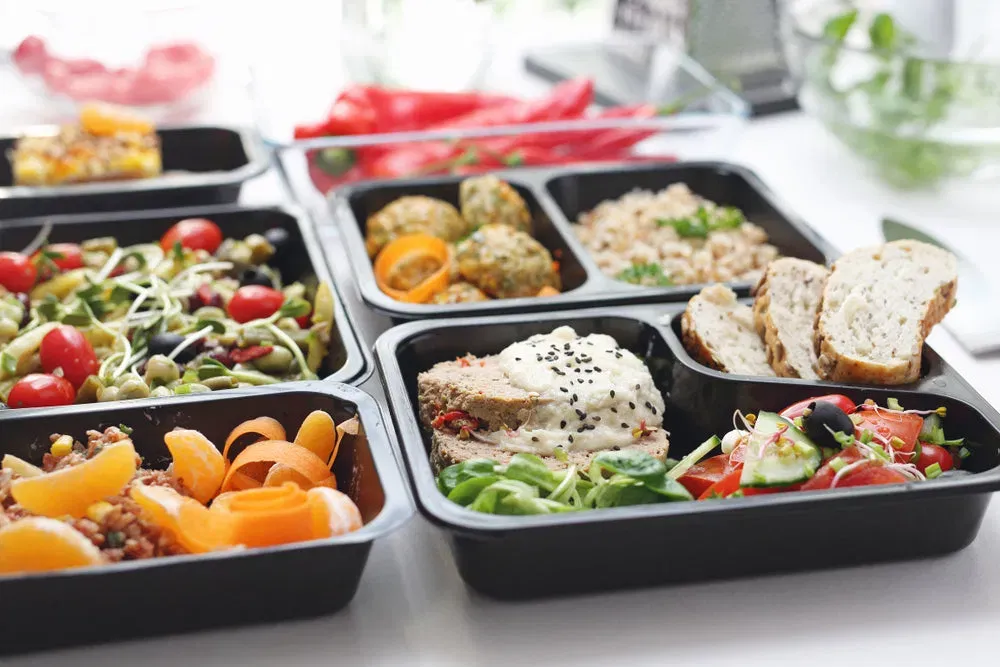 Fresh meal-prep containers with colorful vegetables and proteins